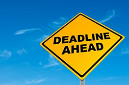 Photo of a roadside sign with the text "Deadline ahead".